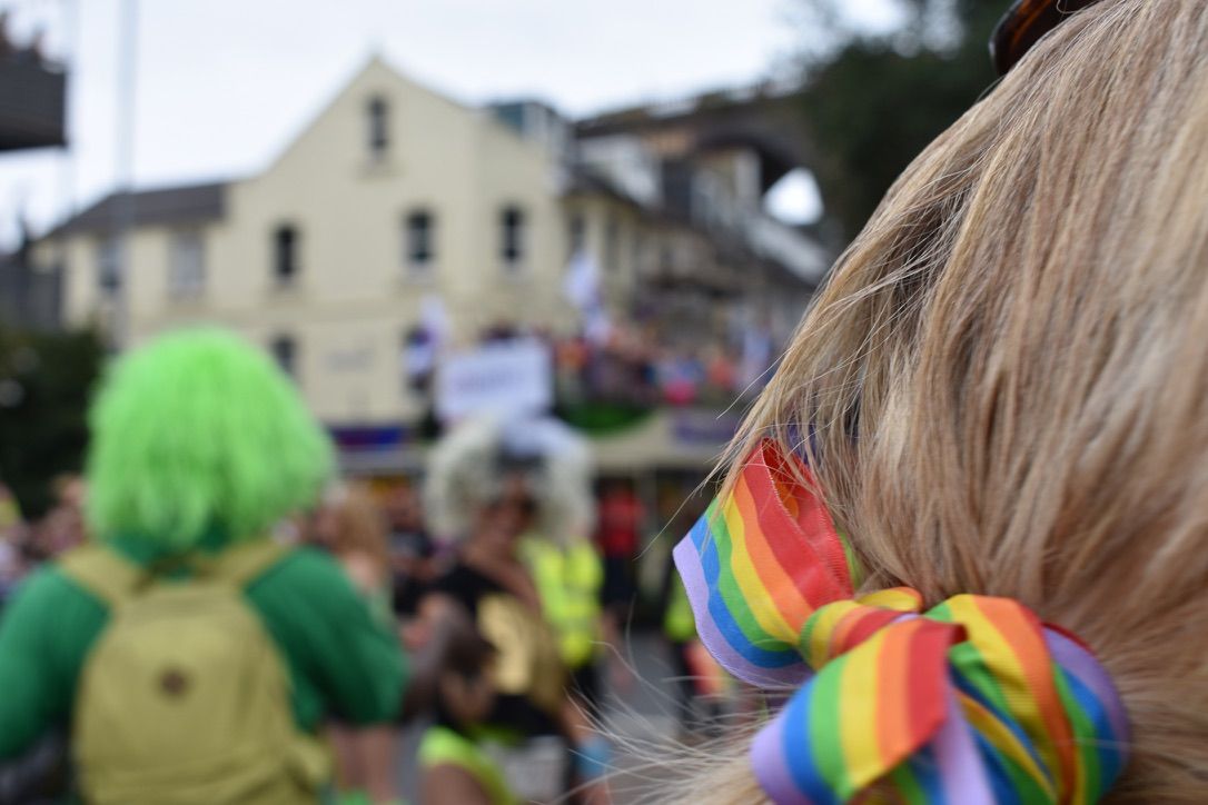 A picture of a rainbow ribbon in a person's hair at Brighton Pride