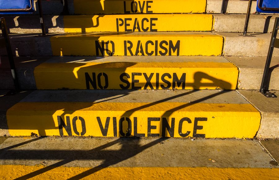Picture of steps at Whitehawk FC ground which read "Love, Peace, No Racism, No Sexism, No Violence"