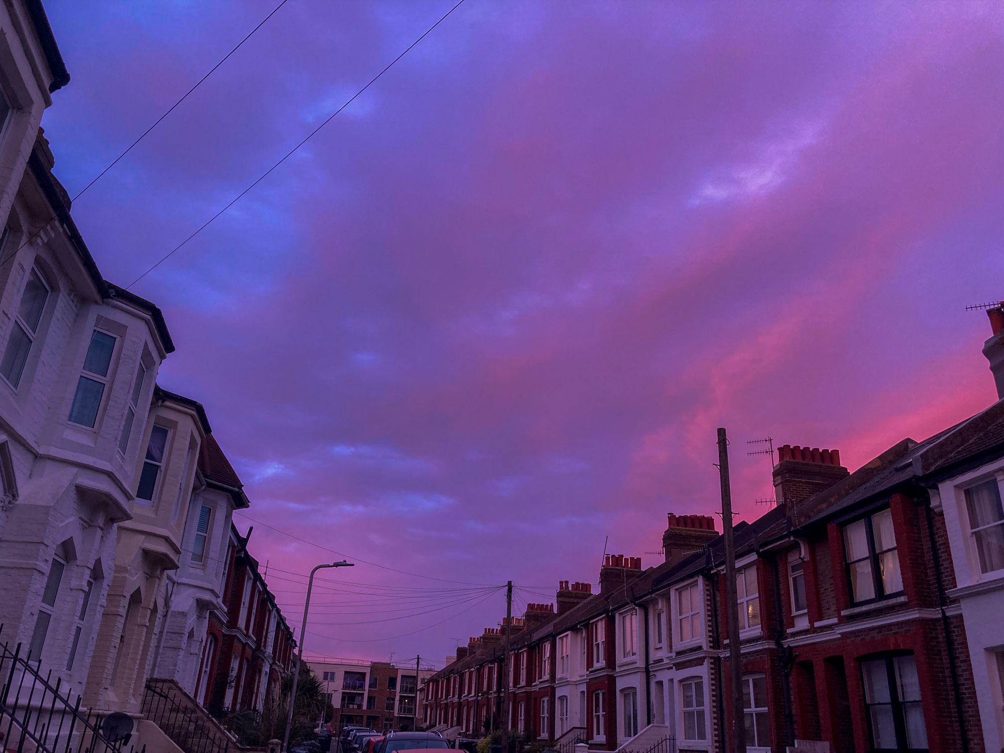 Picture of a bruised sky above a street of houses
