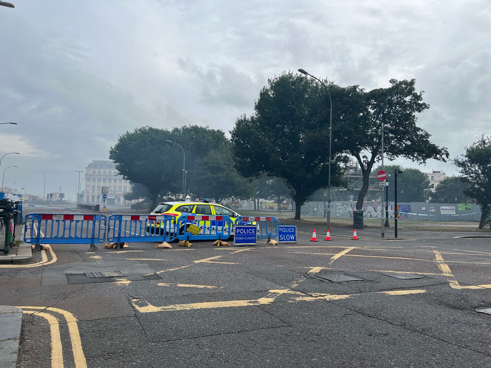 Photograph of a smoke-filled Old Steine with the road closed by police