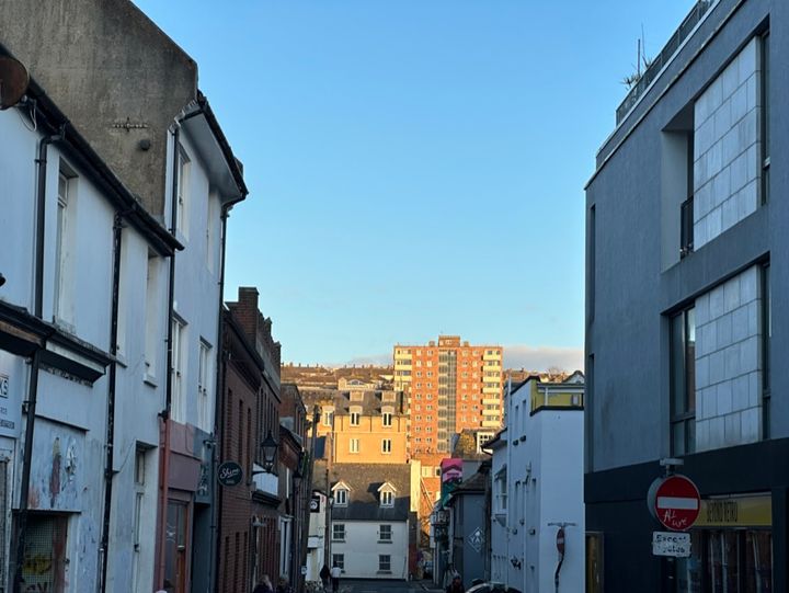 Photos of some tower blocks in the sun with the foreground in shadow