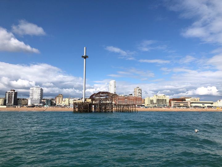 Picture of the West Pier from the sea with the Brighton skyline in the background