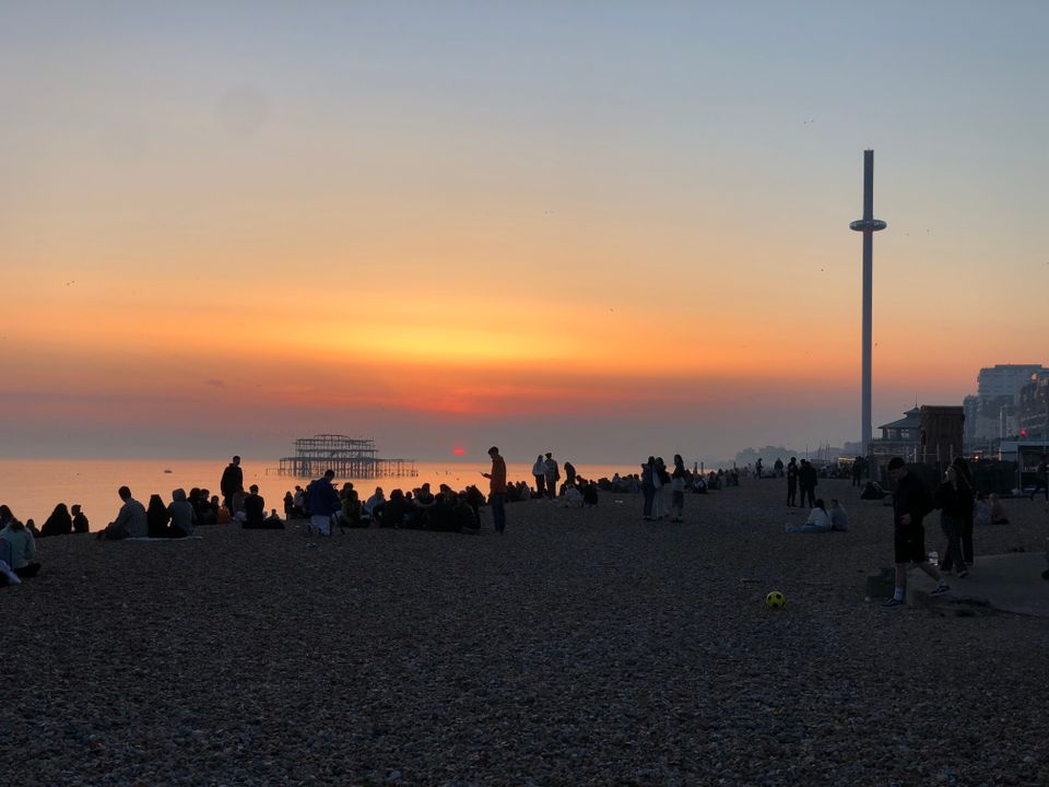 A picture of the sunset behind the West Pier and the beach