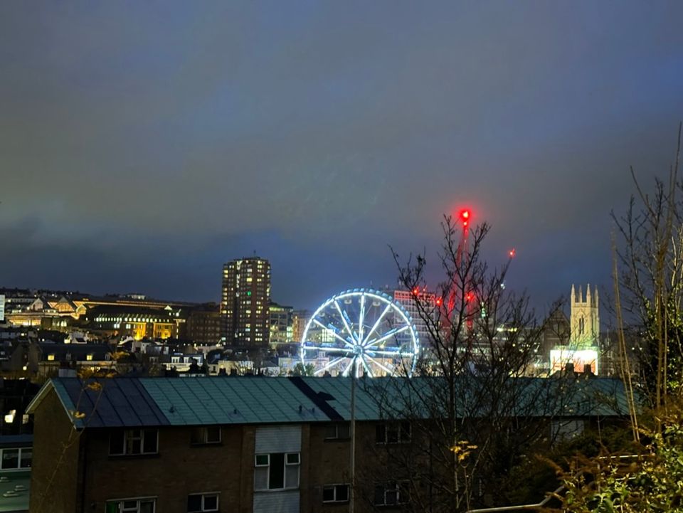 A picture of the wheel in Valley Gardens at night from up the hill