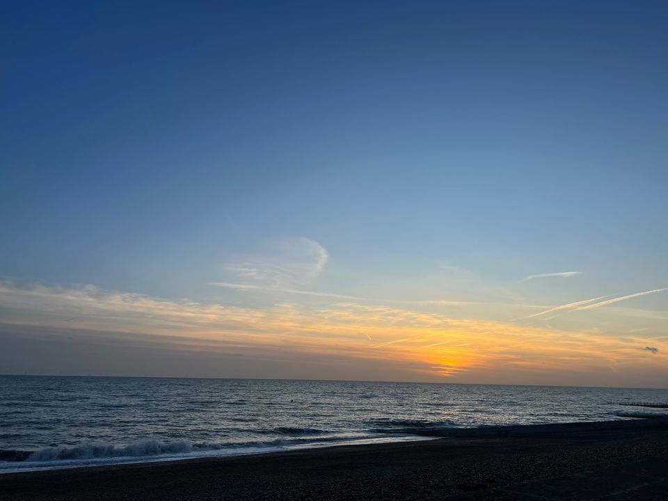 Photograph of a sunset over the sea taken from Brighton beach